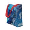 Blue abstract tote bag with red straps.