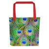 Red tote bag with vibrant peacock feathers.