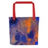 Red tote bag with abstract art.