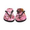 A pair of flip flops with pink flowers on them.