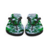 A pair of flip flops with green and white flowers.