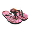 A pair of flip flops with pink flowers on them.