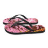 A pair of flip flops with pink flowers on them.