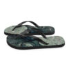 A pair of flip flops with an image of the ocean.