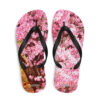 A pair of flip flops with pink flowers on them.