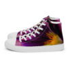 A pair of purple and yellow sneakers on top of a white shoe.