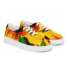 A pair of shoes with yellow and green leaves on them.