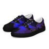 A pair of blue and black shoes on top of a tennis shoe.