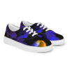 A pair of blue and yellow sneakers on top of a white shoe.
