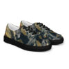 A pair of shoes with a black sole and gold leaf print.