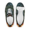 A pair of shoes with a butterfly on them.