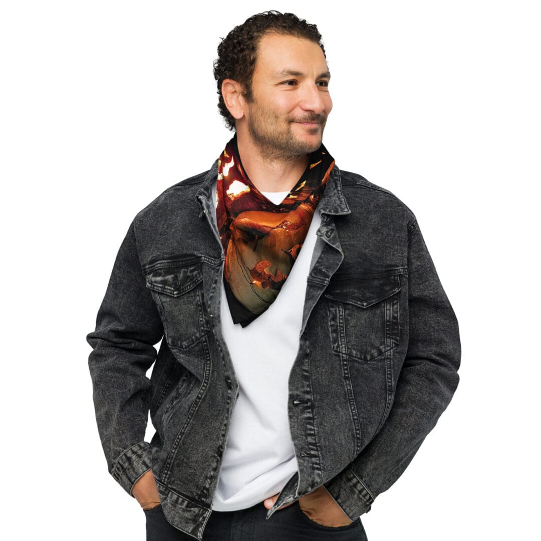 Man wearing denim jacket and patterned scarf.