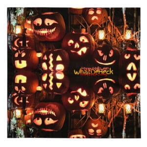 Carved pumpkins with glowing faces at night.
