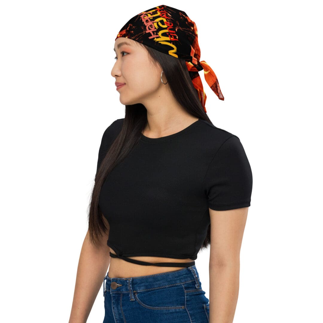 Woman wearing colorful headscarf and black top.