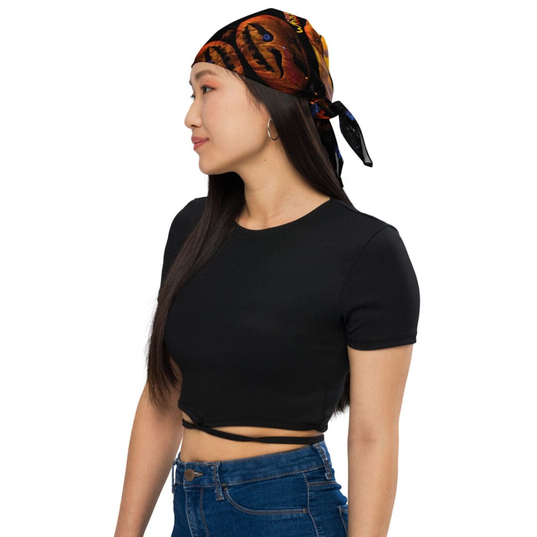 Woman wearing bandana and black top.