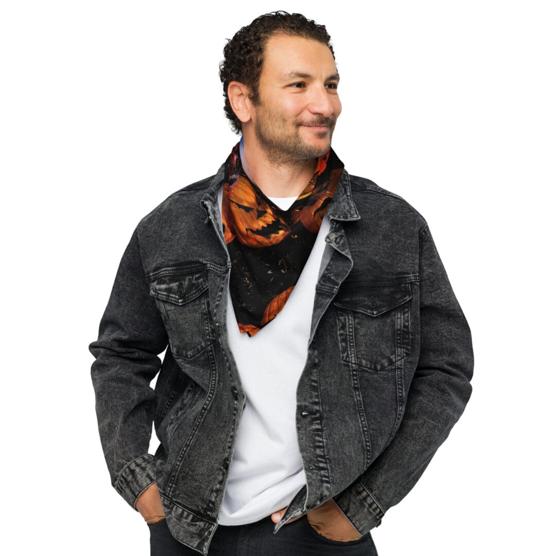 Man wearing denim jacket and printed scarf.
