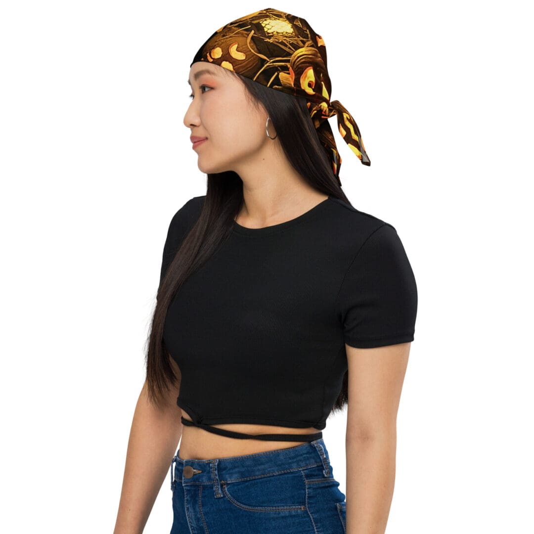 Woman wearing black top and patterned headscarf.