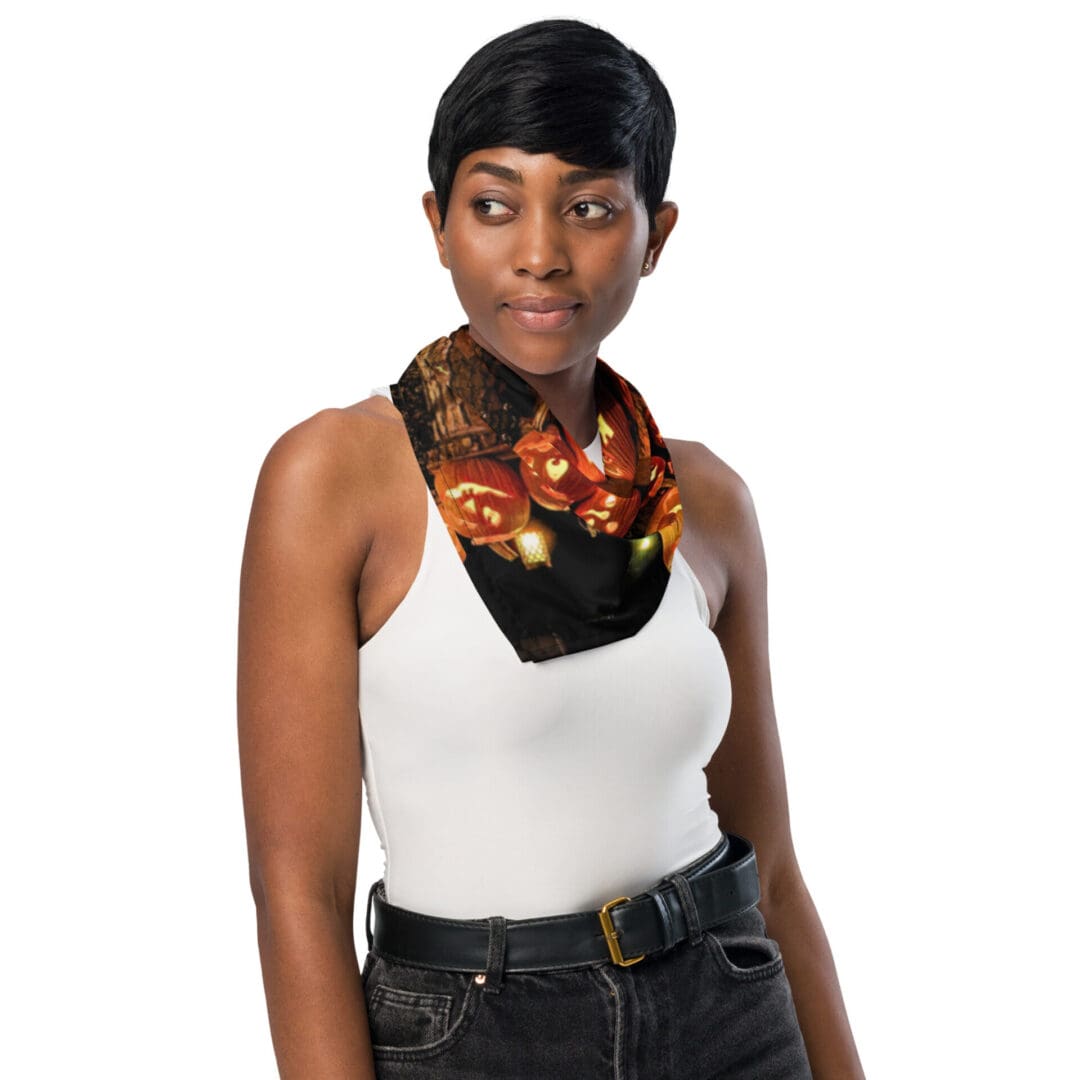Woman wearing Halloween-themed scarf, white top.