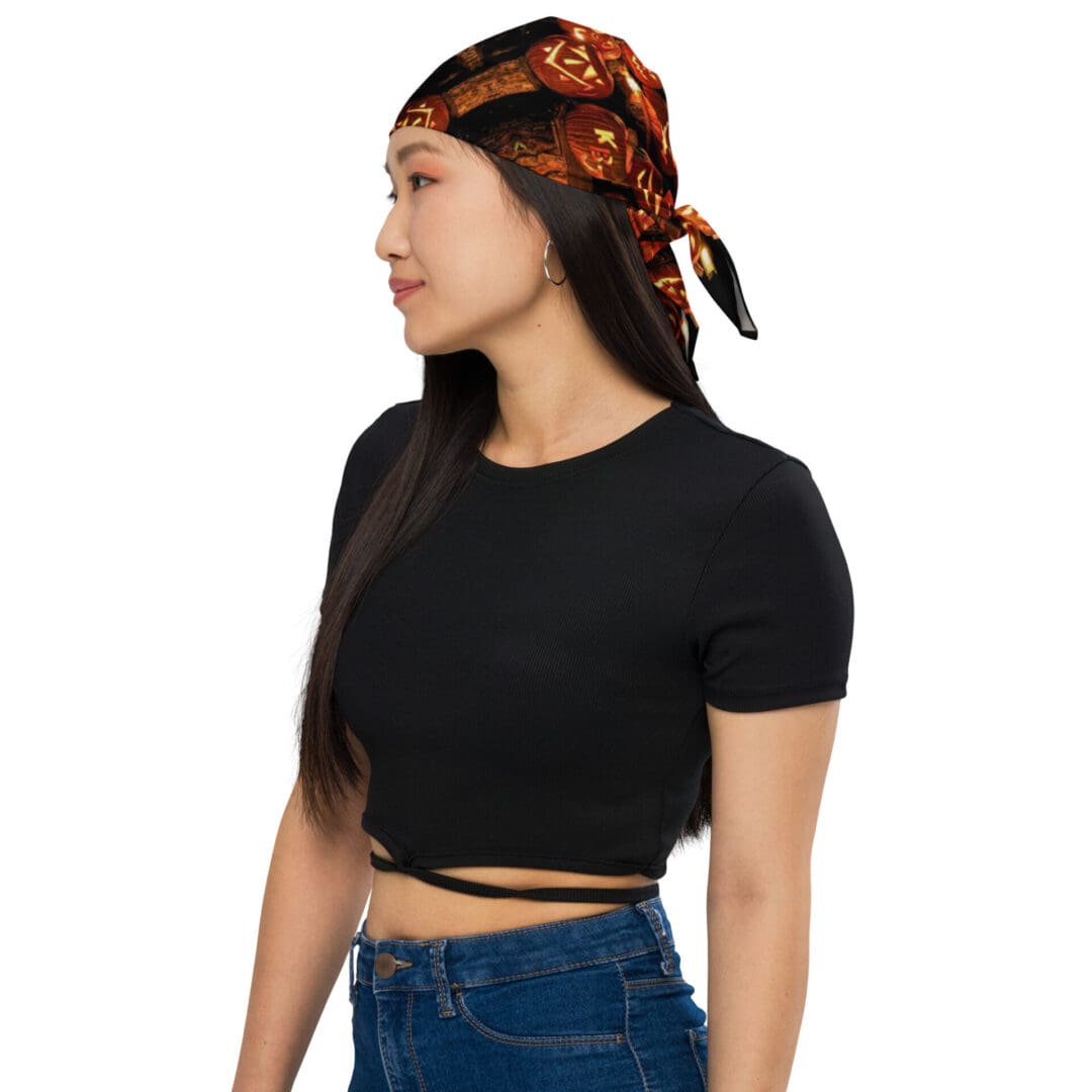 Woman in black top wearing patterned headscarf.