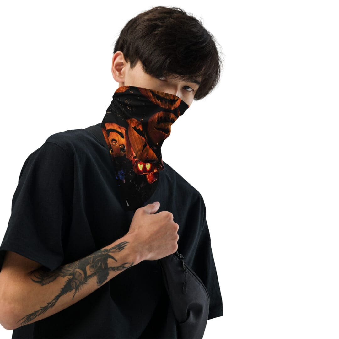 Man wearing printed face covering and black shirt.
