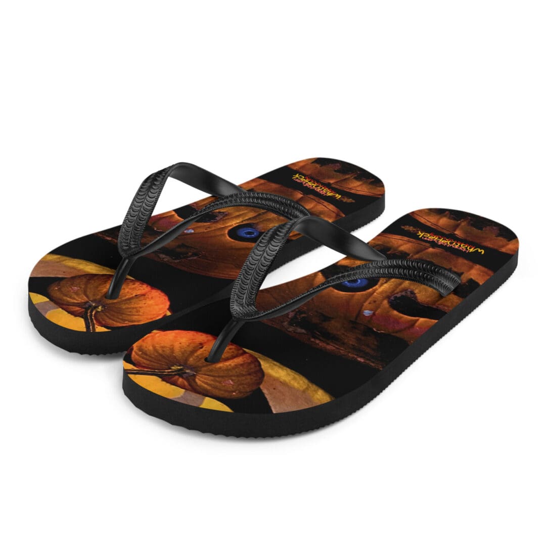 Flip flops with pumpkin design, black straps.