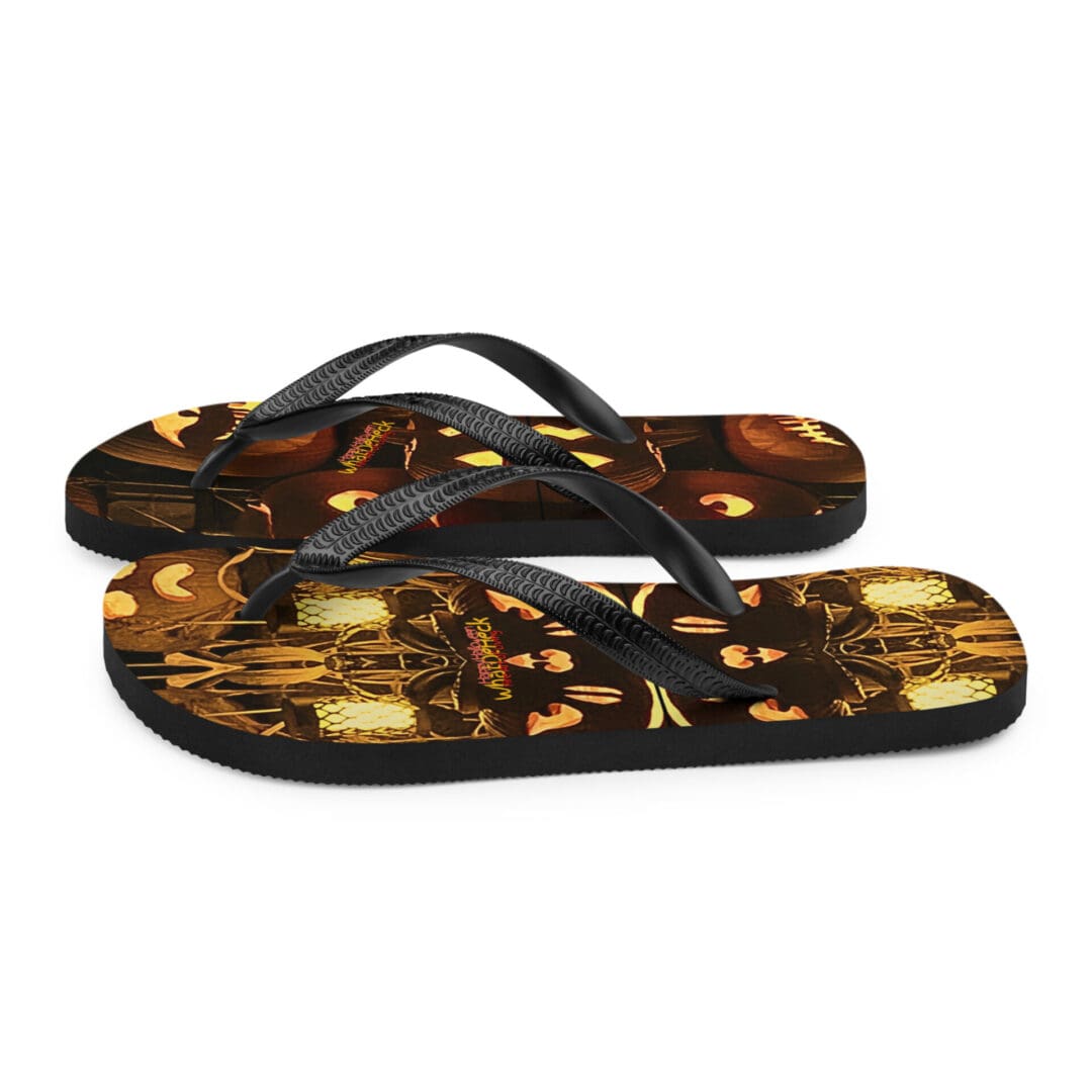 Black flip-flops with Halloween pumpkin design.